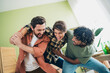 © deagreez - Photo of company three friends laugh fight hang out weekend modern interior apartment indoors