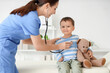 © Pixel-Shot - Female pediatrician with stethoscope listening to cute little boy in clinic