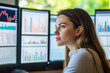 © romanets_v - Young caucasian female analyzing financial data on multiple monitors in office