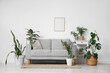 © Pixel-Shot - Interior of living room with sofa, table and green plants