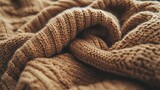 Soft, brown knitted fabric with intricate patterns and textures