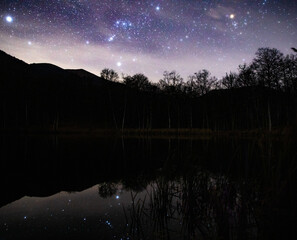 Wall Mural - night landscape with stars and milky way on the mountain