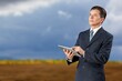 © BillionPhotos.com - Farmer business man at work in corn field.