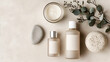 © Minimal & Cozy - Flat Lay of Neutral-Toned Skincare Bottle with Eucalyptus Leaves, Stones, and Minimalist Spa Aesthetic on Beige Background
