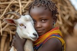 African girl from Dasanesh tribe holding goat in village.