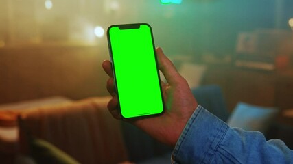 Close up man hands using a mobile phone with green screen. Social media. Smartphone. Mock up