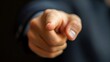 © DARIKA - Businessman pointing his finger at a dark background, with a blank area for text, representing focus, clarity, and the power of non-verbal communication in business.