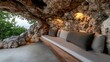 © Raul - Relax and unwind on this cozy bench nestled within a natural rock cave, overlooking a tranquil ocean view. The warm lighting and neutral tones create a serene atmosphere.