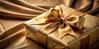 © Nasnunt - Elegant golden ribbon tied around a present with a beautiful bow, sitting on a luxurious velvet tablecloth , golden gift