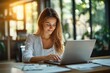 © btiger - Cheerful mid-aged businesswoman working on laptop in modern office smiling at work professional manager in corporate environment