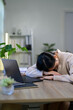 © Parichat - Young businesswoman sleeping on the office table after working late into the night, feeling overwhelmed and stressed by an excessive workload and looming deadlines