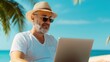 © Vilaysack - A relaxed man works on a laptop by the beach, wearing sunglasses and a straw hat, surrounded by palm trees and ocean views.