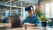 © Vilaysack - A woman using a virtual reality headset while working on a laptop in a modern office space.