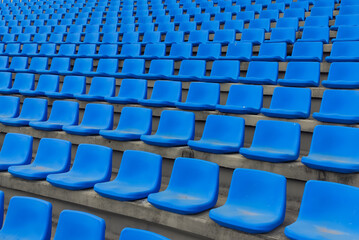 Closeup of blue seats in a stadium bottom to top view