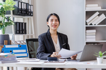 Wall Mural - Business asian woman working at office with documents on desk, doing planning analyzing the financial report, business plan investment, finance analysis concept	
