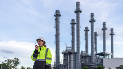 Sticker - Engineers wearing safety gear, including hard hats examining survey detail standing industrial facility gas or oil refinery engaged in a job requires high safety standards concept.	