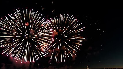 Poster - Spectacular fireworks display lights up the night sky over the city skyline during a festive celebration