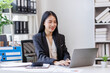 © David - Happy busy young business woman entrepreneur in office using laptop at work, smiling professional asian female company executive manager working looking at computer at workplace.