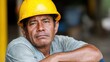 © Business Image - Contemplative construction worker in hard hat reflecting on work challenges