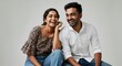 © gn8 - Joyful young indian couple in casual attire sharing a moment of laughter for lifestyle and happiness themes