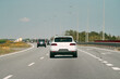 © AlexGo - White car traveling down an open road.