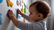 © eco_ - Baby Girl Playing with Colorful Animal Shaped Magnets on a White Wall, Developing Fine Motor Skills and Exploring Shapes
