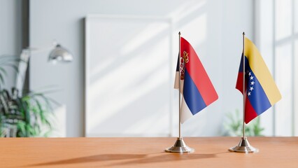 FLAGS OF SERBIA AND VENEZUELA ON TABLE