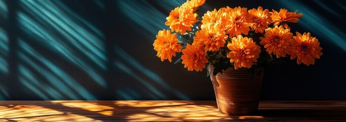 Aufkleber - Bright orange mums in pot, sunlit table, blue background with shadows.