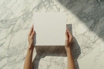 Poster - Hands holding blank square on marble.