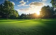 © ma - Beautiful green lawn with trees in the park, sunlight shining through clouds on the grass, creating a serene and peaceful atmosphere.