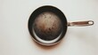 © Suphawan - Minimalist frying pan with a flat base and stainless steel handle, centered on a white background