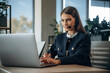 © standret - Call center, in headphones. Woman is working in the office