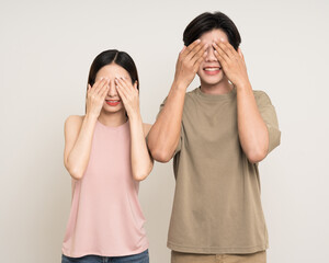 Wall Mural - Close the. eyes guess what Happy asian couple attractive in various action gesture standing on isolated white background. Cheerful Smiling young man and woman hide and seek