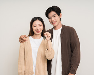 Wall Mural - Happy family asian couple attractive in various action gesture holding house key on isolated white background. Cheerful Smiling young man and woman buy new home showing key of the house