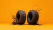© sabyna75 - Rugged off road tires with dynamic mud splatters on vibrant orange background