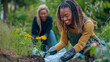 © Patrick - Women, planting flowers for gardening and growth in nature, with care, and work or activity. African, and caucasian people working outdoor for environment, sustainability, organic farm