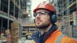 © Seak - A man wearing noise-canceling earmuffs while working in a noisy construction environment, with tools and machinery around him