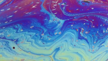 Wall Mural - Closeup video of a soap bubble showing thin film interference concept and the resulting different colors of light with each moving and swirling shapes. Perfect for illustrating concepts of physics.