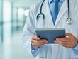 © VISA-3UK - Health info doctor using tablet for patient consultations in modern clinic environment