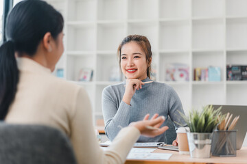 Wall Mural - Two women having professional discussion in modern office