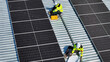 © FotoArtist - Installation of Solar Panels on a Rooftop by Workers in Safety Gear During Daylight
