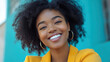 © korawik - woman smiling confidently with bright, natural teeth, showcasing her joyful expression against vibrant background. Her curly hair and stylish outfit enhance her cheerful demeanor