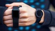 © watcharee - A close-up of two stylish black watches on a person's hands, showcasing modern design and technology.