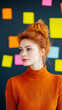 © pawimon - Creative woman in orange sweater with colorful sticky notes