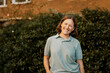 © Maskot - Portrait of happy female healthcare worker in front of plants