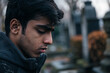 © Tetiana - Generative AI image of mourning young man in cemetery grief and respect for dead person