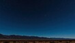 © Maryna - Starry night sky over desert landscape with mountains in distance. Dark night with many stars visible. Desert plain stretches under vast dark blue sky full of stars. Rocky mountain silhouettes at
