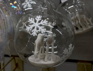 two white deers in the transparent christmas ball