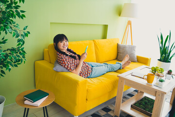 Wall Mural - Full body portrait of nice young girl use smart phone sofa free time modern green yellow interior flat indoors