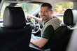 © New Africa - Happy man behind steering wheel of modern car